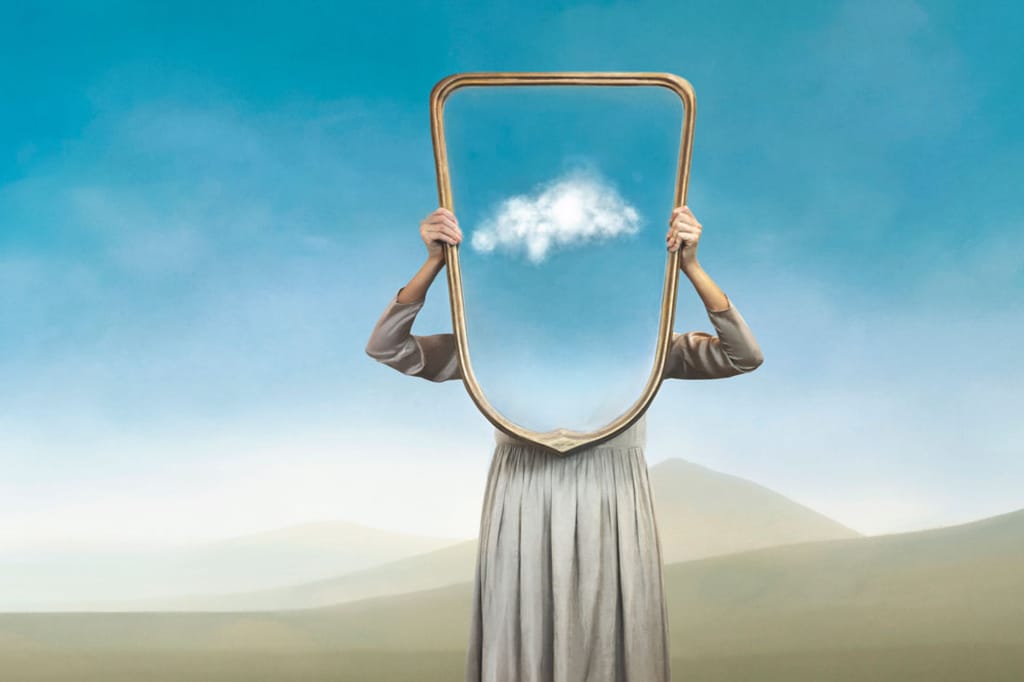 A person holding a frame with a cloud where their head should be.