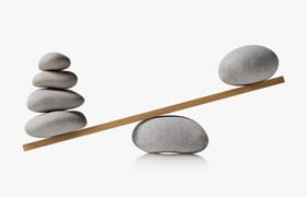 A balance with uneven weights of stones stacked to signify workload analysis.