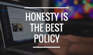 Honesty is the best policy in white on a background photograph of a person working remotely on a laptop.