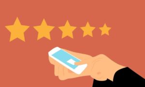 5 yellow stars above a person touching their smartphone with one finger.