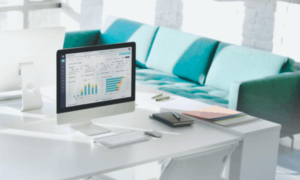 A computer on a white desk in a house. It shows ActivTrak employee monitoring software.