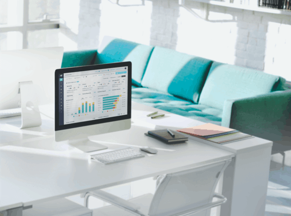 A computer on a white desk in a house. It shows ActivTrak employee monitoring software.