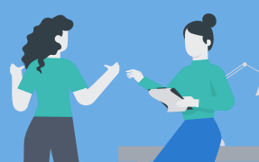 2 women talking to each other. One is holding a clipboard, with productivity management info, and is sitting on a desk.