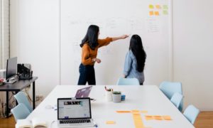 two woman working in an office together