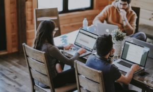 Team sitting at a table improving workplace productivity
