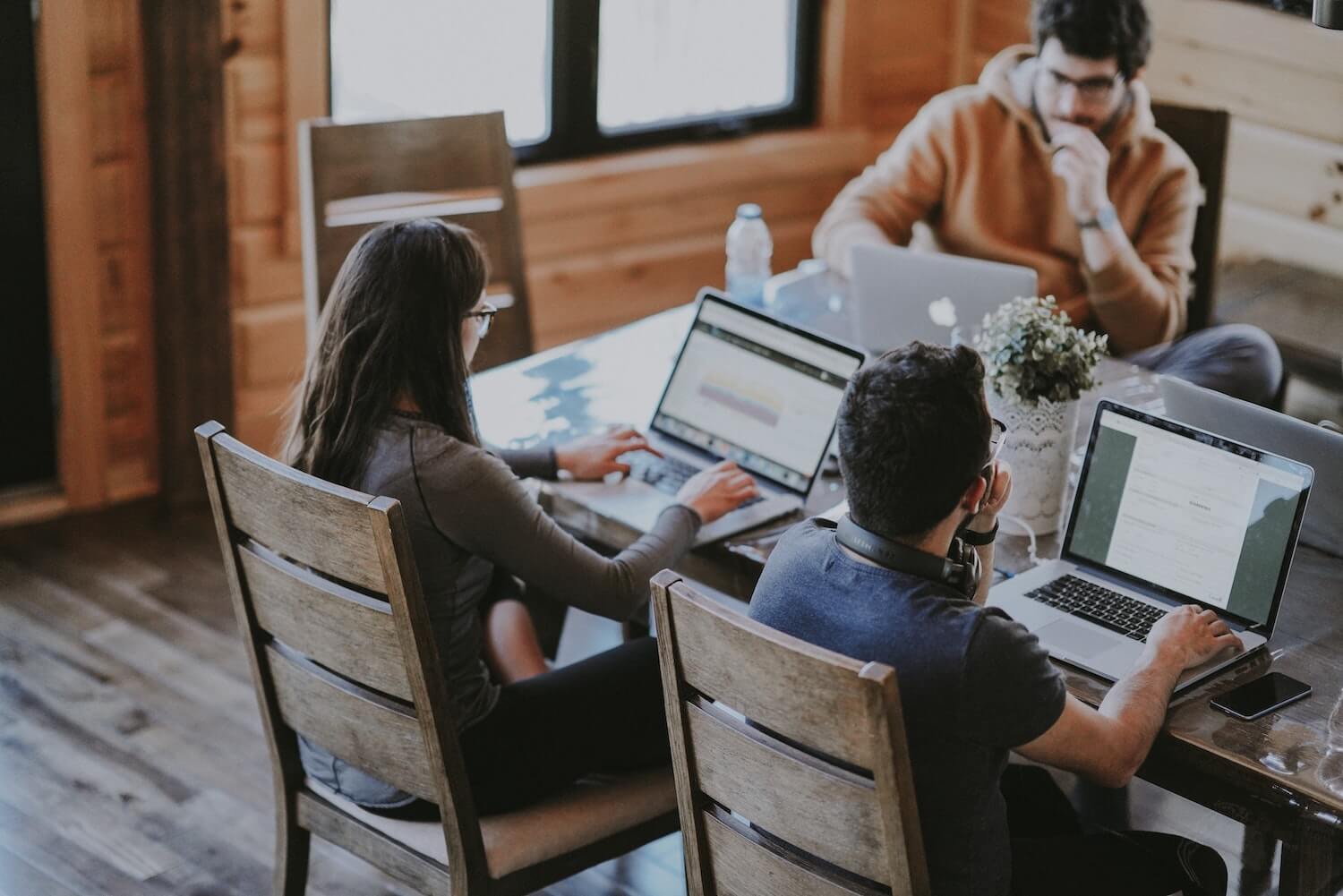 Team sitting at a table improving workplace productivity