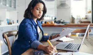 A woman actively engaged in a project at work.
