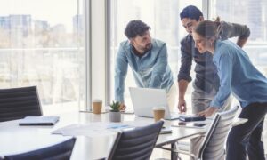 A team of 3 employees deciding on new technology to improve productivity at their organization.