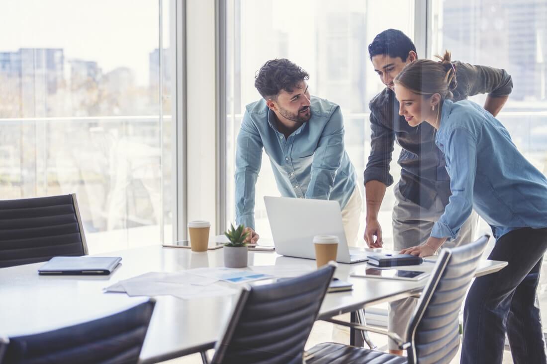 A team of 3 employees deciding on new technology to improve productivity at their organization.