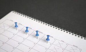 Calendar with pins on the 4 days of the week for a 4 day work week trial.