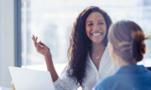 Two employees having a positive conversation about productivity, collaboration and engagement.