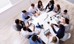 A team of employees happily working around a table