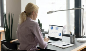 A manager reviewing a report from employee visibility software like ActivTrak.