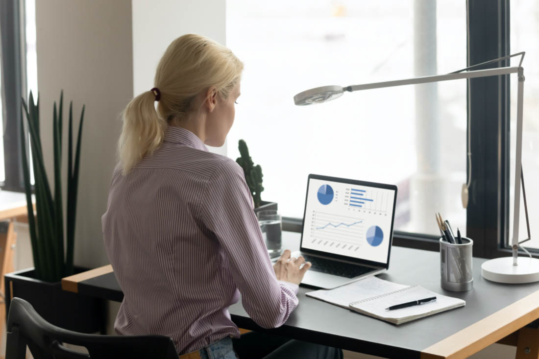 A manager reviewing a report from employee visibility software like ActivTrak.