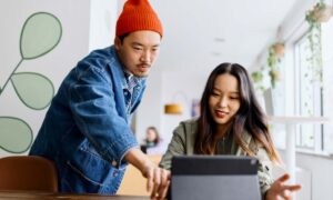 Two employees using an AI tool to get their work done faster.