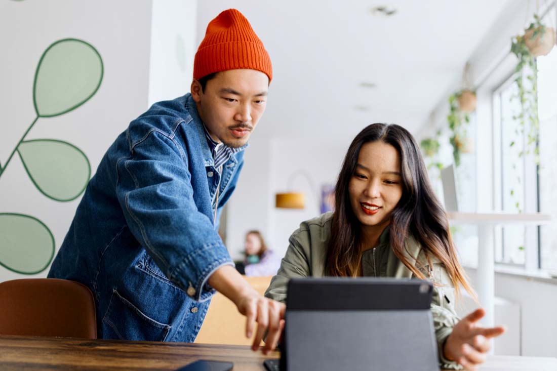 Two employees using an AI tool to get their work done faster.