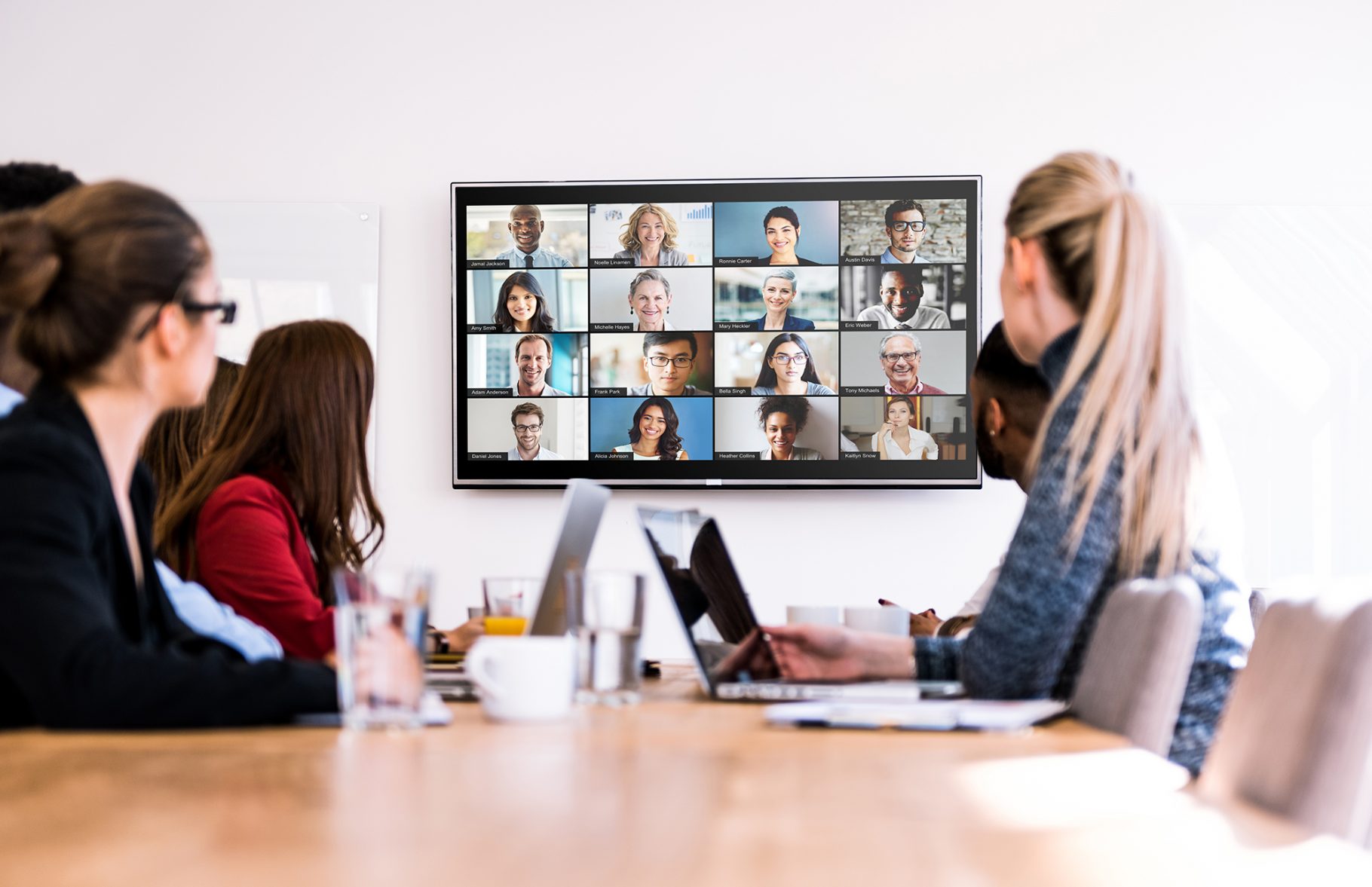 a team using Zoom as a remote work software to conference with remote team members. 