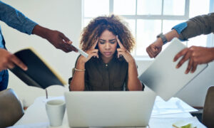 A burned out employee being bombarded with tasks, which begs the question, how is productivity affected when employees multitask?