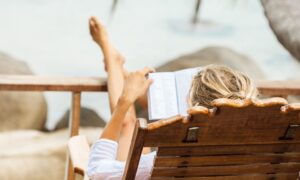 A person reading on the beach.