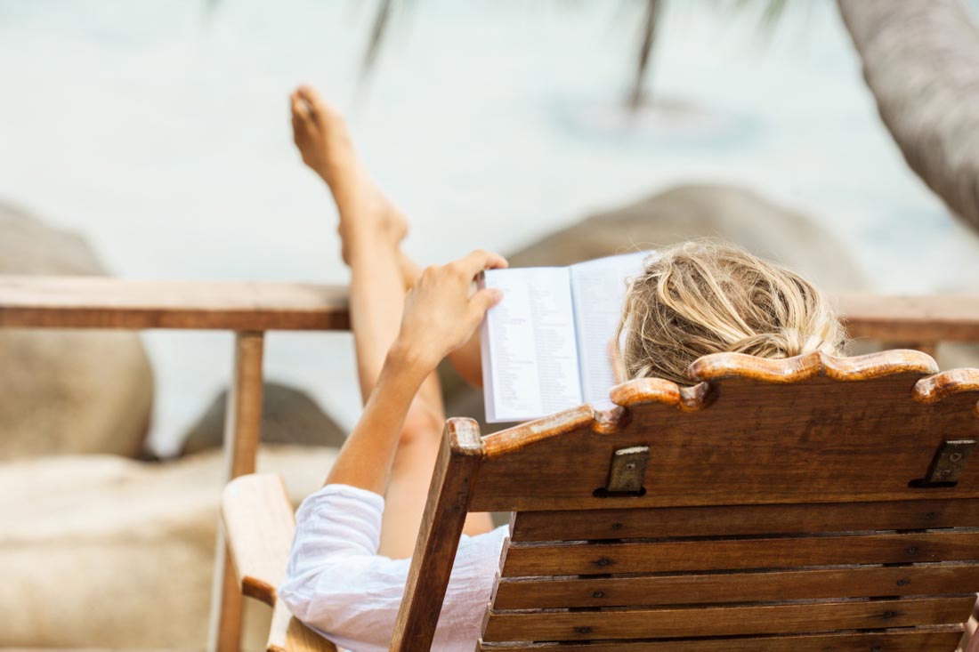 A person reading on the beach.