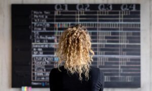 a businesswoman analyzing quarterly workforce planning metrics to plan for the future.