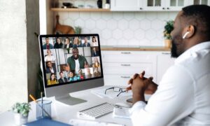 An employee working in a remote work environment on a zoom call.