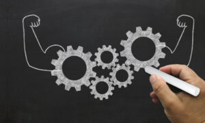 Gears with arms flexing to symbolize team productivity tools working together to achieve business goals.