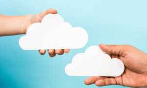 Two hands hold clouds to signify the need for cloud-based SaaS application visibility