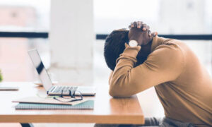 An overworked employee experiencing the challenges of virtual teams.