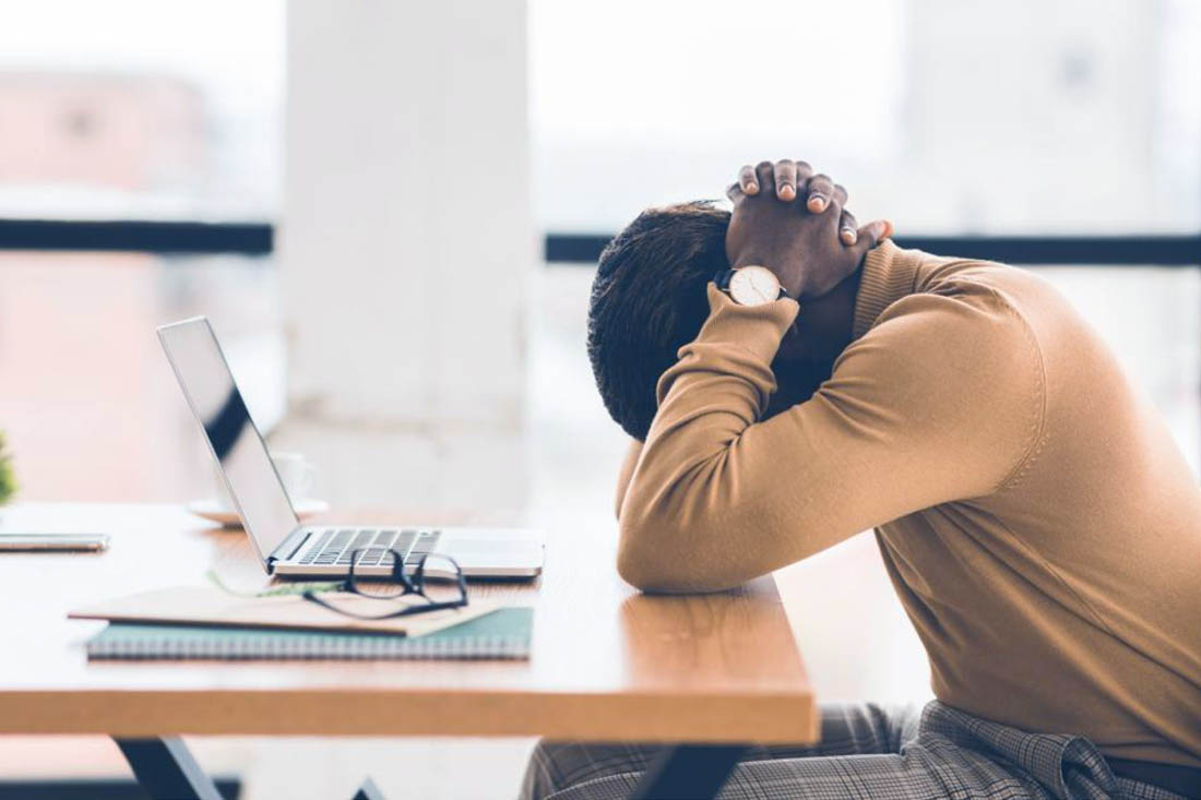 An overworked employee experiencing the challenges of virtual teams.