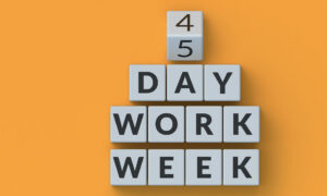 A picture of blocks with letters changing to 4 day work week benefits.