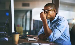 An overworked employee straining to continue work.