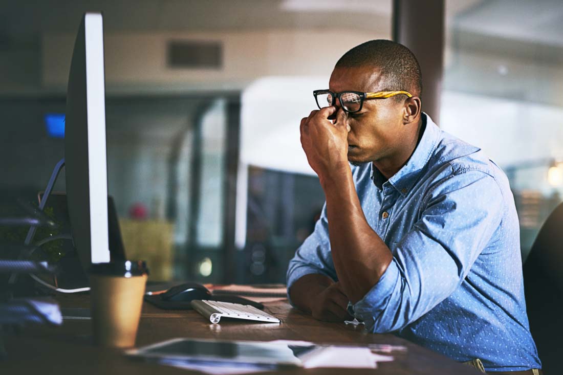 An overworked employee straining to continue work.