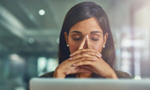An employee struggling with workload in their office.