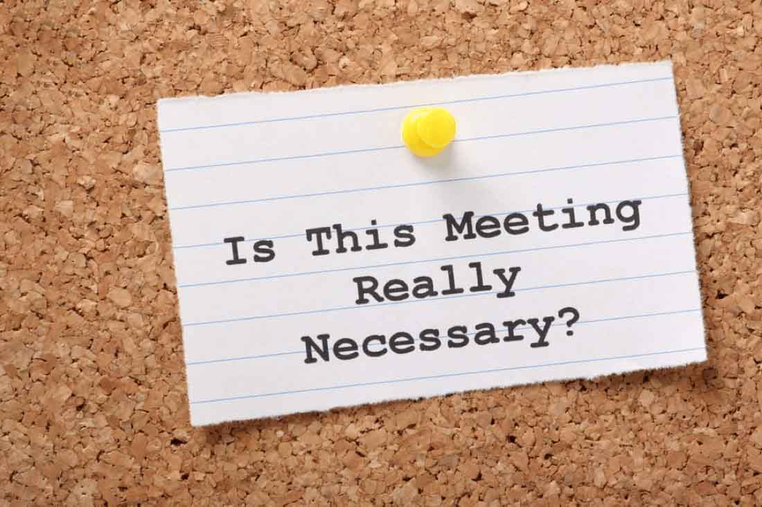 A note card with the words “is this meeting really necessary?” because meetings are common distractions in the workplace.