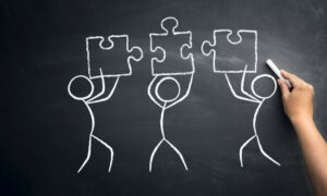 An illustration of a team using effective workload distribution to solve a puzzle.