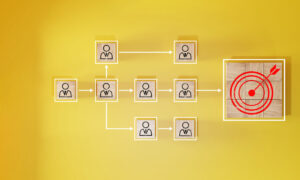 An org chart shown in wood tiles, pointing towards a target to signify role alignment.