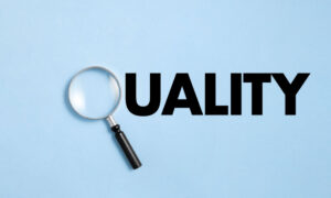The word Quality spelled out, where the Q is a magnifying glass to symbolize how to measure quality of work