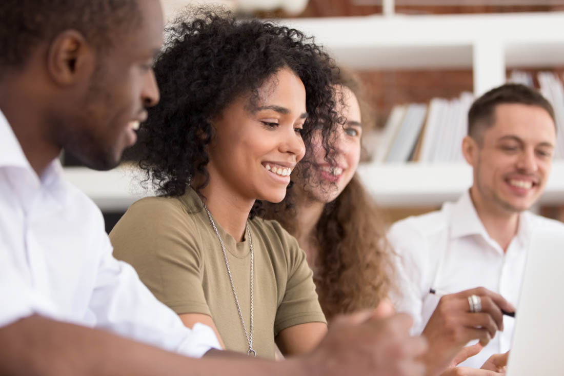 4 employees in an office training where their company has decided to invest in employees