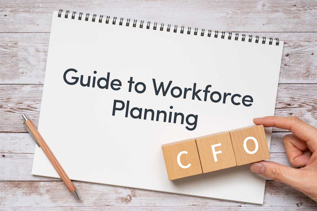 A notebook that says guide to workforce planning with wood blocks that read CFO in the bottom corner.