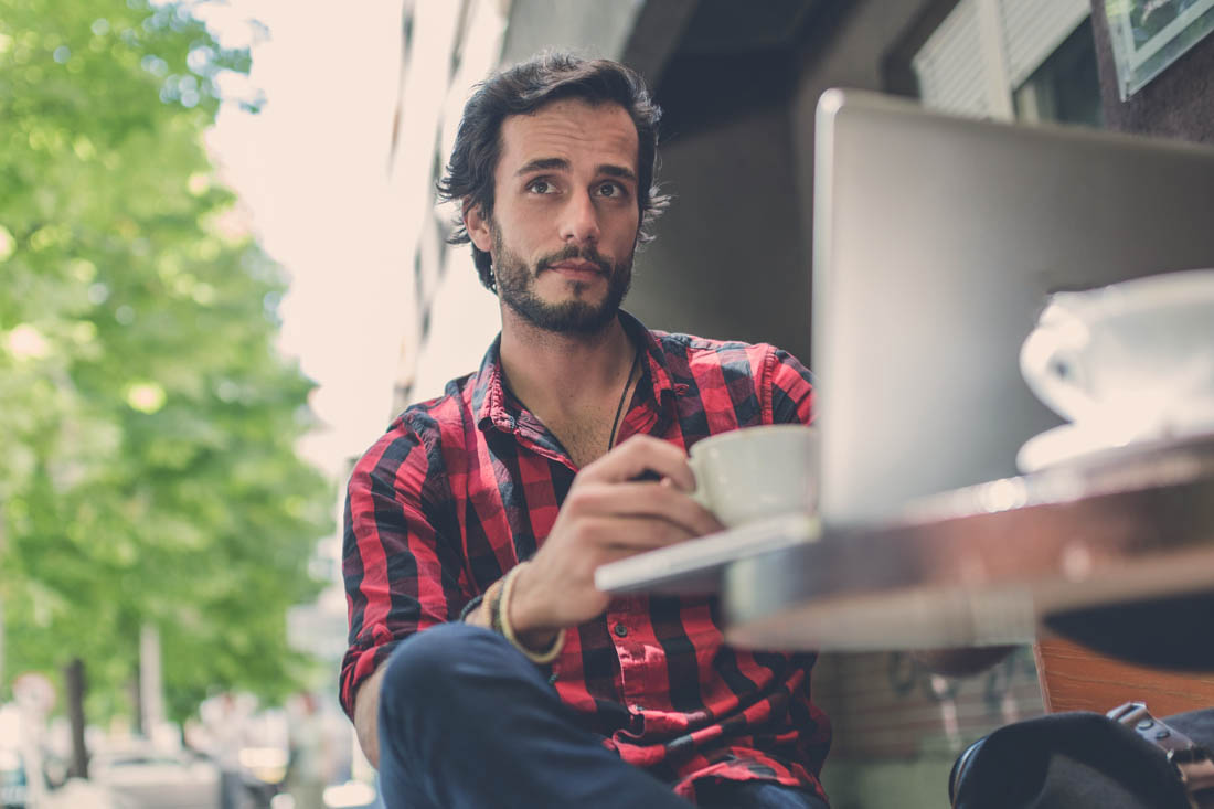 An employee working remotely due to his company’s remote workforce strategy.