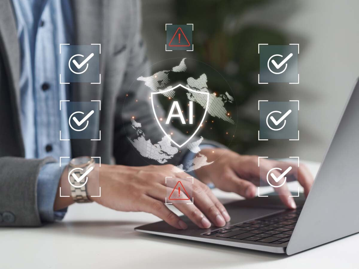 Executive at laptop surrounded by checkmark and AI icons