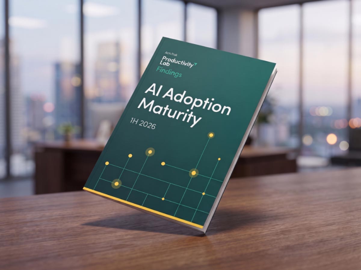 Primary SEO Alt Text (Recommended) ActivTrak Productivity Lab Findings report cover titled AI Adoption Maturity displayed on a wooden desk.